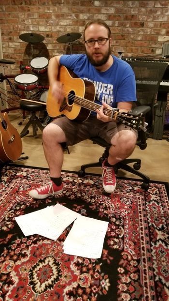 Matt Griffith warming up the acoustic guitar.
