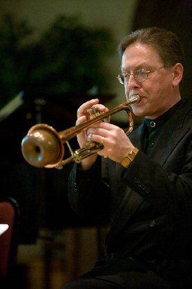 Jeff Stockham blowing a muted horn
