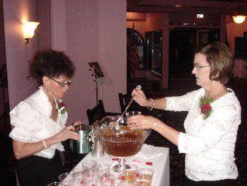 Joyce and Peg serving the punch with a red heart shaped ice cube
