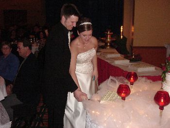 Nick and Amanda cutting their wedding cake with passion
