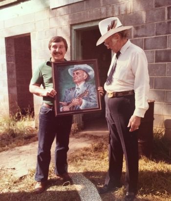 Bill Monroe admires Greg's portrait of him
