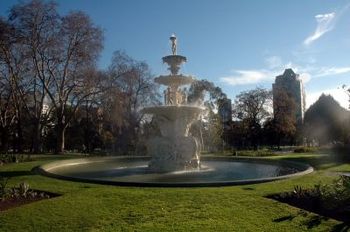 It appears the large trees to the left would provide the 'canopy of leaves' for Whatzizzname's shot.  His shot deletes the pool of water, emphasizes symmetrical landscaping and cradles the fountain wi
