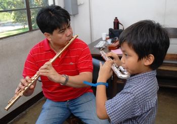 My little brother Panhlauv with his flute teacher Mr. Maigue
