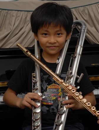 My little brother Panhlauv posing with different flutes
