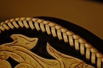 Close up view of the Laced edge of a leather covered Guitar
