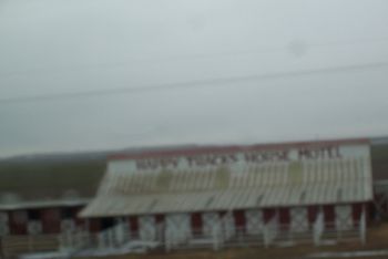 It says "Happy Tracks Horse Hotel." I am no photographer...sorry.
