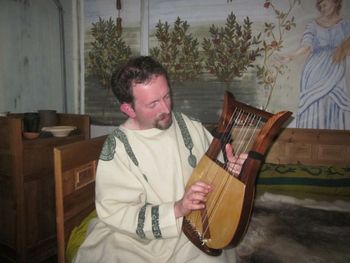 Performing in the replica Roman Villa at Butser Ancient Farm Performing in the replica Roman Villa at Butser Ancient Farm
