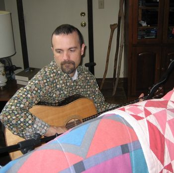 Tim May, Session Leader, in action behind the flat pick guitar quilt
