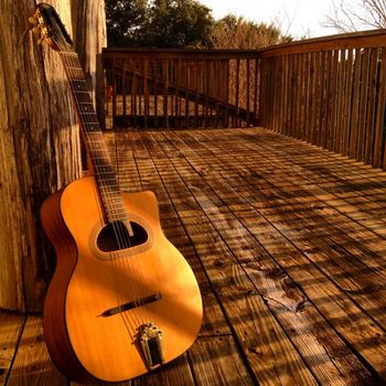 Willie's Django guitar on the porch at sunset
