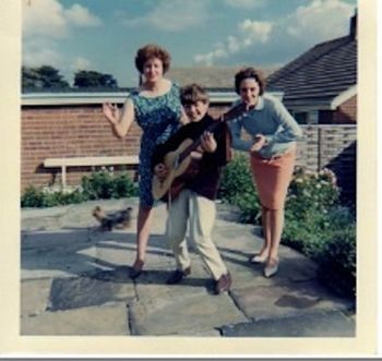 Robin and his first guitar with his Mum and Auntie
