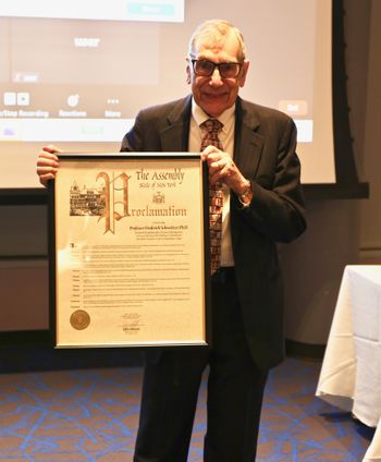 Dr. Schweitzer with proclamation commemorating the founding of the Holocaust Resource Center in 1996
