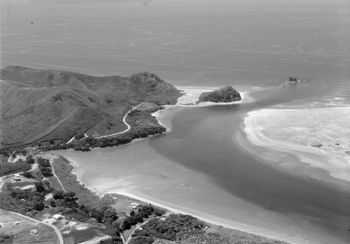 a very lazy lookin Mangawhai Heads (Northland)...1953 With nice little lines coming across the bar.....just think.......no one had even heard of surfboards here then!!!...empty lonely waves!!
