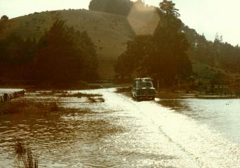 Kevin Price in his 105e Prefect...negotiating flood waters on the way to Whananaki.... Xmas of '73
