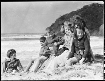 Robert Wells Junior, with the Armstrong children....Matapouri 1946 good swell that day!!....
