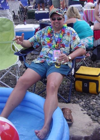 DSC02761 Bob being totally "Chillax" at the Pittsburgh Jimmy Buffett Tailgate before the show.  Good friends, good music, feet in the water, chair somewhat in the sand and There Ain't Nothing Like A Beer (and a good stogie!)
