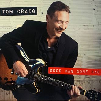 Picture of the cover of Blue's musician Tom Craig's new album Good Man Gone Bad. The cover image features Tom smiling and holding his guitar.