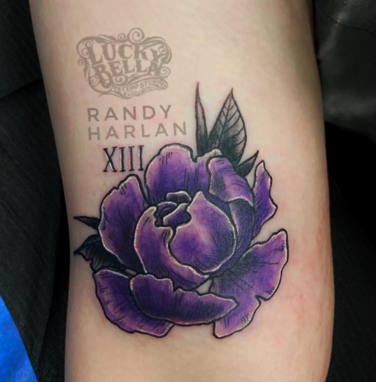 Purple peony tattoo on the right upper arm