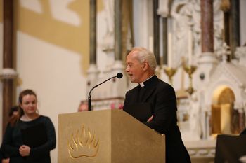 Cappella's first chairman Fr Eugene O'Hagan thanks Donal McCrisken for his 23 years of service to the choir at the end of the Renewed in Song concert. Photograph - Vincent McLaughlin
