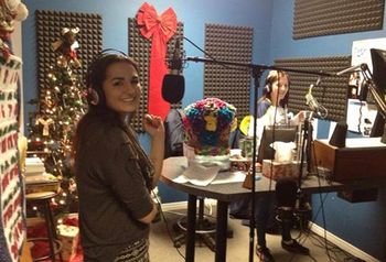 Photo #1 "Chanelle Albert chatting with Sophie Bergeron before she performs "Santa Baby" in support of "Stocking The Shelves" Radiothon for the West Nipissing Food Bank” Steph Larouche *December 11, 2015 – Moose FM, Sturgeon Falls, Ontario
