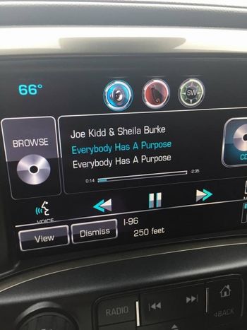Joe Kidd & Sheila Burke Everybody Has A Purpose broadcast on car radio dashboard

