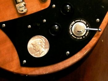 I'm really excited to share this recent modification from the Maton Custom shop! Back in 2003 when I won the International Blues Challenge in Memphis, The Preacher gave me a 1935 American Silver Dollar as a celebration gift. It's a nod of respect to pioneering blues guitarist Memphis Minnie, who famously wore a silver dollar bracelet. The tone pot changes on my Mastersound had left a blank hole in the scratch plate, so we had the brilliant idea of setting my keepsake dollar into it - and I reckon it looks great!
