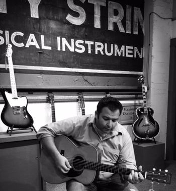 Brandon picture 4 Brandon test driving a 1940 Martin 0028 at Dusty Strings in Seattle, WA
