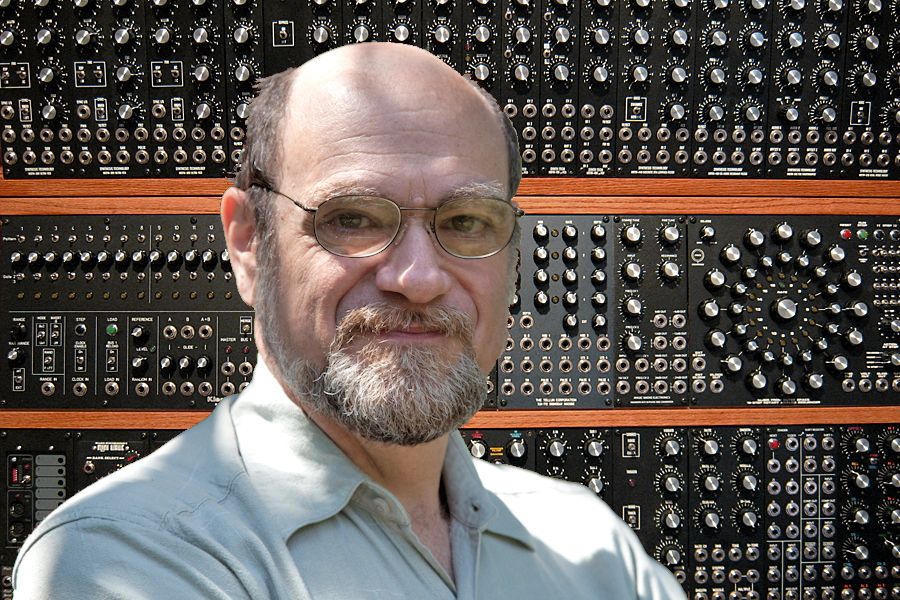 Image of MW Gilbert in front of synthsizers