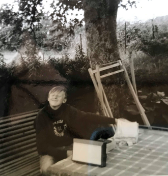 Reidar i hagen hos sine besteforeldre i Skånevik på 1960 tallet. Lytter til musikk fra en portable platespiller. Sannsynligvis Kinks eller The Rolling Stones