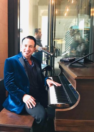 "Sing us a song, you're the..."PIano Mann!" Photo: David Mann performs at "Perrys Steakhouse" piano bar