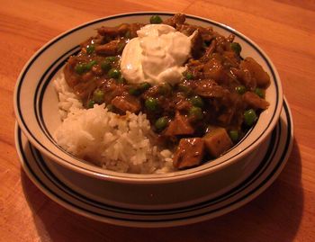 Turkey Curry with Potatoes, Peas and Sour Cream on White Rice
