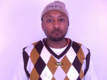 J.O.T. wearing an argyle diamond pattern SOUL-FULL WEAR V-NECK sleeveless sweater
