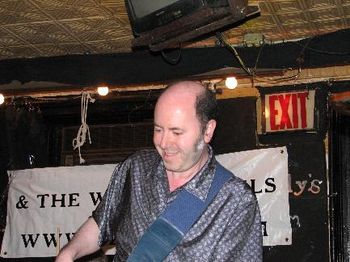 Andy playing & smiling, photo by Greg Ross
