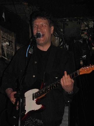 Ian playing + giving the finger which seems eminently appropriate at this esteemed and closing punk rock venue.
