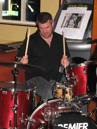 In this shot of Tom drumming you can see one of our posters and a pint of real ale.
