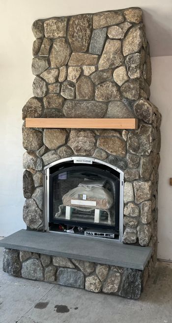 Fieldstone veneer fireplace with thermal gauge bluestone hearth
