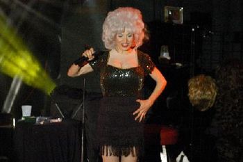 "One Voice" live show image - Bethany on-stage as Dolly Parton during the "Country Queens" show segment
