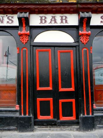 I loved the colors of this pub door.  Also the sort of tipsy tilt of the steps and red trim.
