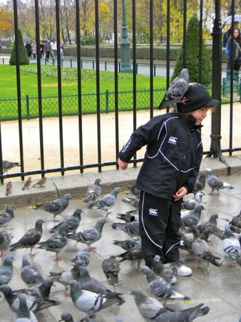 Across the street from Notre Dame Cathedral, Sunday morning, right after Mass.  The little girl has bread crumbs on her hat.
