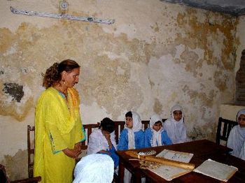 Annie listening to children singing at school for blind girls
