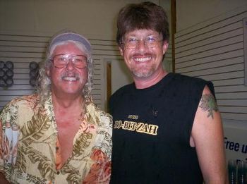 With Arlo Guthrie after a very wet opening set. (Wyland Wall Dedication)
