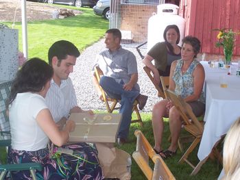 Meggan and fiance Andrew open gifts while Andrew's parents Barbara and Bob look on
