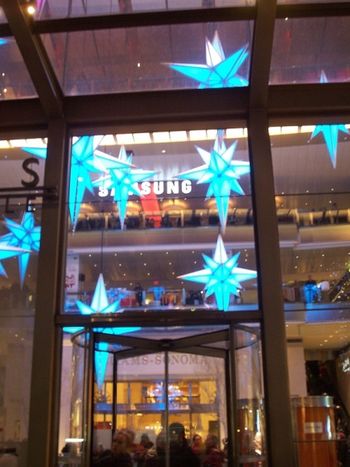 A dozen 14 foot stars hanging from the ceiling of The Great Room at the Time Warner Center
