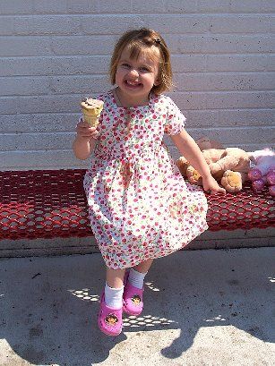 Evelyn is having her ice cream and wearing it, too!
