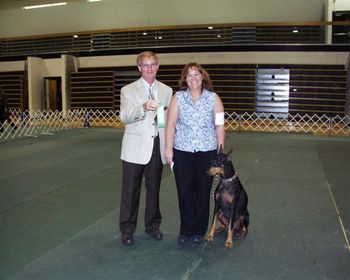 Robyn and Tori earning the 3rd leg for a Companion Dog (CD) title at the Savannah Dog Training Club trial on July 16, 2006. Pictured with judge Greg Feathers.
