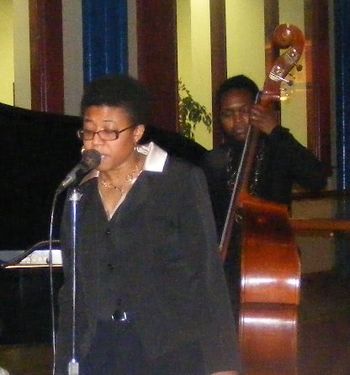 Daille gets on the bandstand to sing while Miriam caresses the bass
