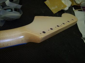 Some maple-shade nitro lacquer is sprayed over the splice seam
