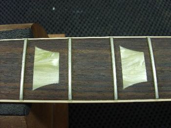 You're looking at the snot green inlays in a late model Gibson Les Paul Classic.  It's very obvious, Gibson didn't quite nail that vintage look with these.
