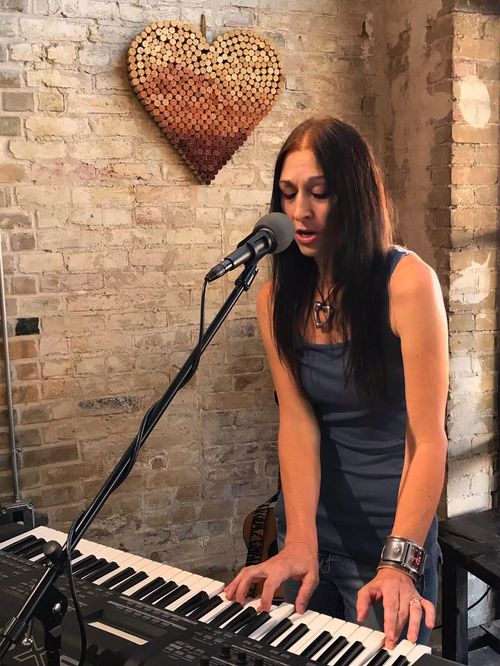 Gospel Blues Singer Songwriter Kimberlee M. Leber playing her Yamaha MOEX6 Keyboard during a live performance
