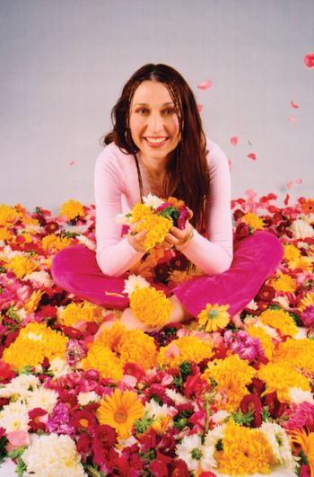 Promotional Picture of Kimberlee M Leber in a Sea of Flowers
