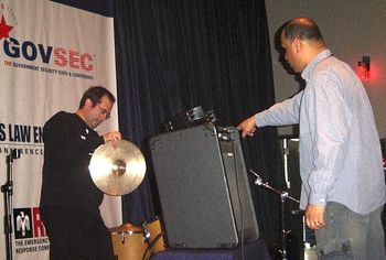 GOVSEC 4/26/06: Either Stan is directing the setup or telling Rob that is a cymbal...only they know for sure.
